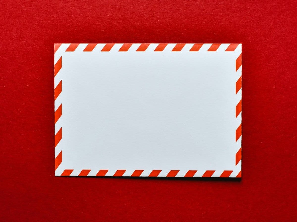 An envelope prepared with authentic Forever stamps for a client mailing