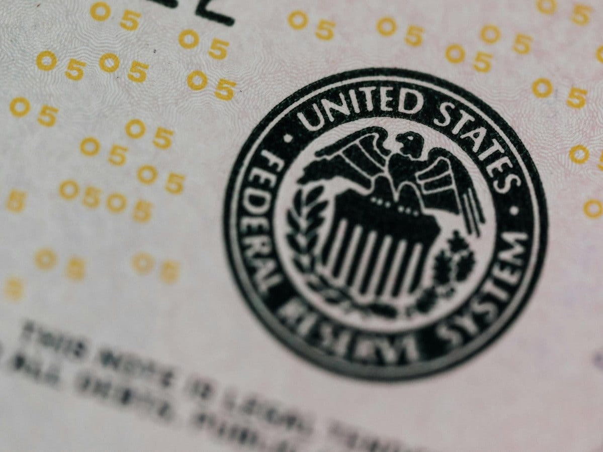 An operations lead comparing the security differences between counterfeit and verified stamps.